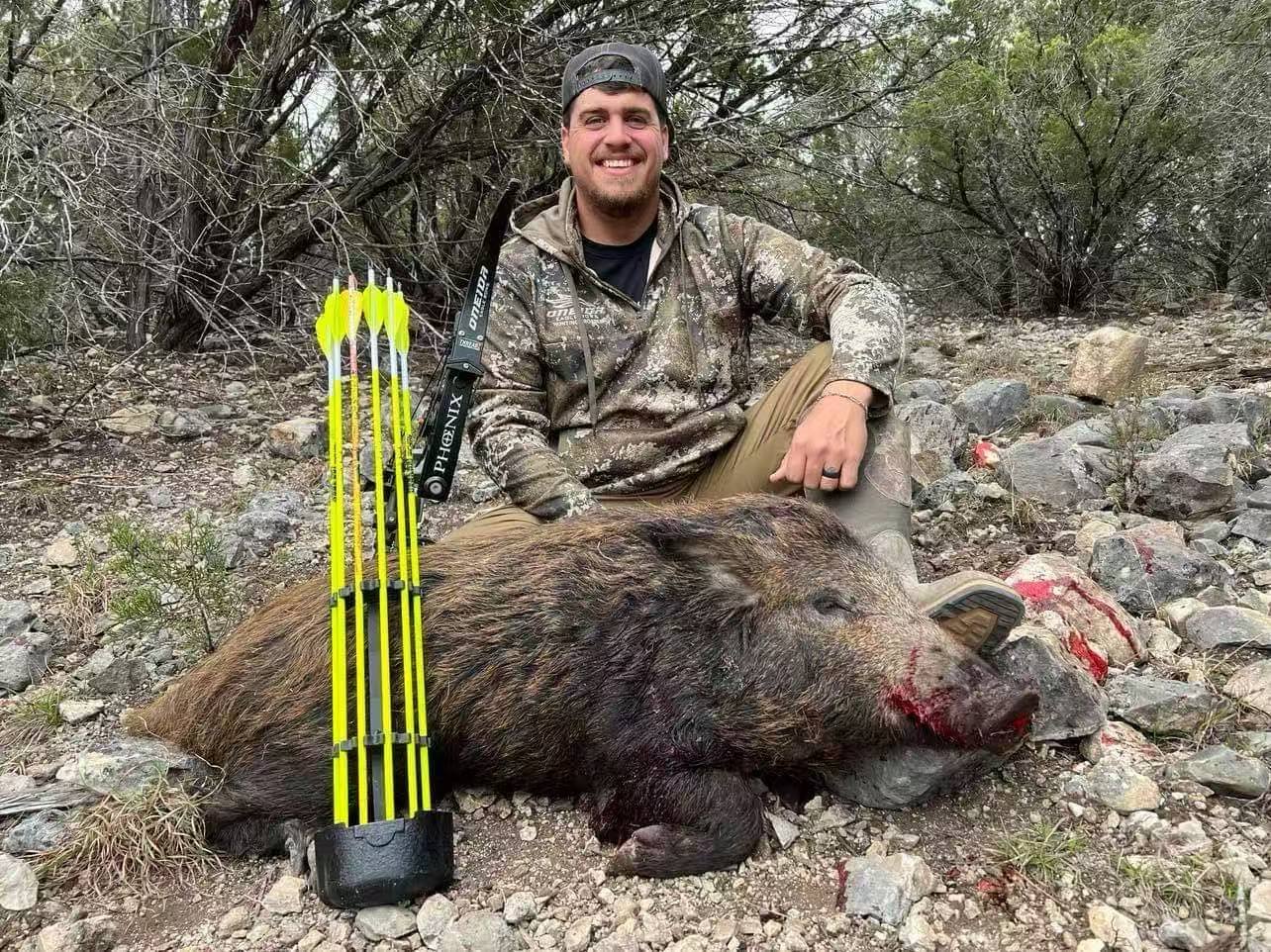 Hunter with a hog, flo-yellow arrows in the quiver